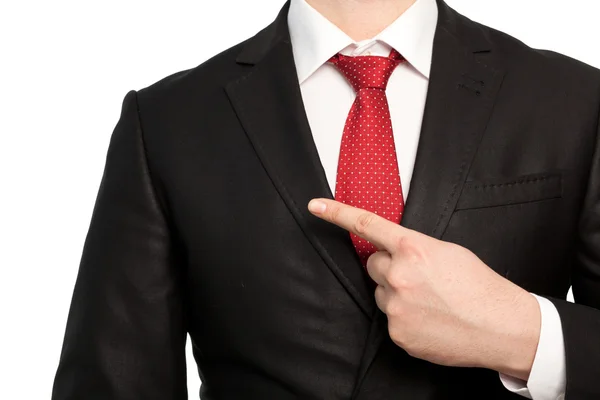 Isolated businessman in a suit points the finger at an object — Stock Photo, Image