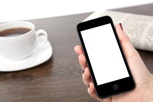 Zakenvrouw hand met een telefoon tegen de achtergrond van de — Stockfoto