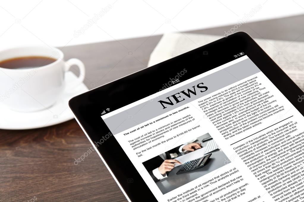 tablet with business news on screen on a table at a businessman