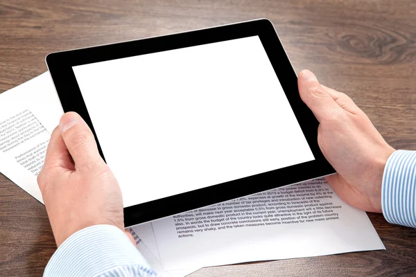 Businessman holding a tablet on the table with documents — Stock Photo, Image