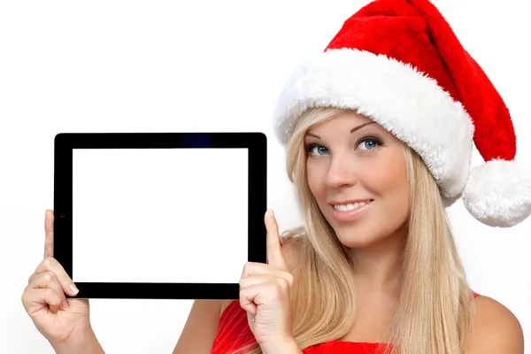 Chica en un sombrero rojo de Navidad en Año Nuevo, la celebración de la tableta toque pa —  Fotos de Stock