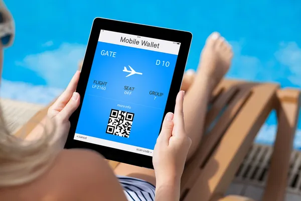 Girl lying on a deck chair by the pool and holding a tablet with — Stock Photo, Image