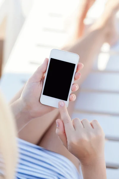 Dokunmatik telefon ile bir şezlong üzerinde yatan bir mayo içinde kız — Stok fotoğraf