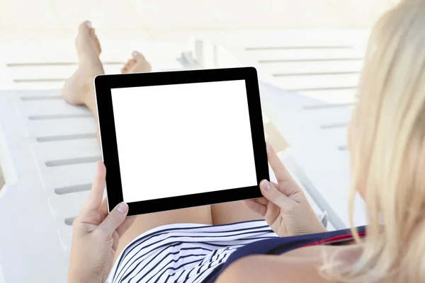 Girl in a bathing suit lying on a chaise lounge with a computer — Stock Photo, Image
