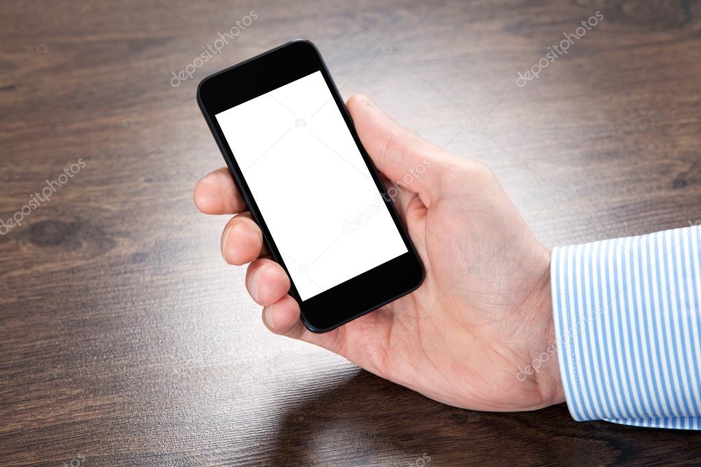 businessman holding a phone with isolated screen over the villag