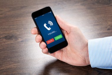 bir telefon ile mavi ekran ve telefonun ringi tutan işadamı