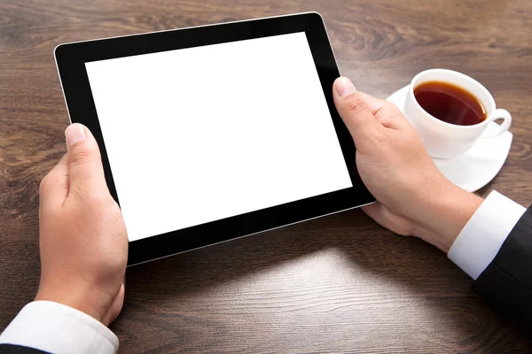 Businessman holding a tablet with isolated screen over the villa — Stock Photo, Image