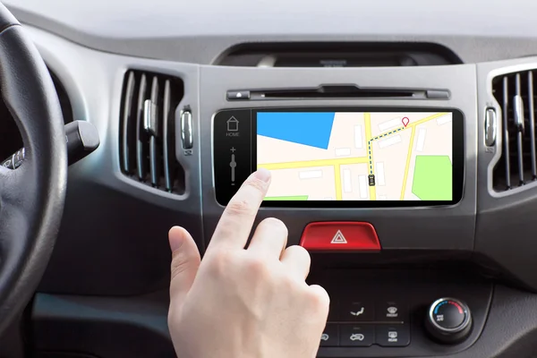 Man sitting in a car and touch play finger in a navigation map — Stock Photo, Image