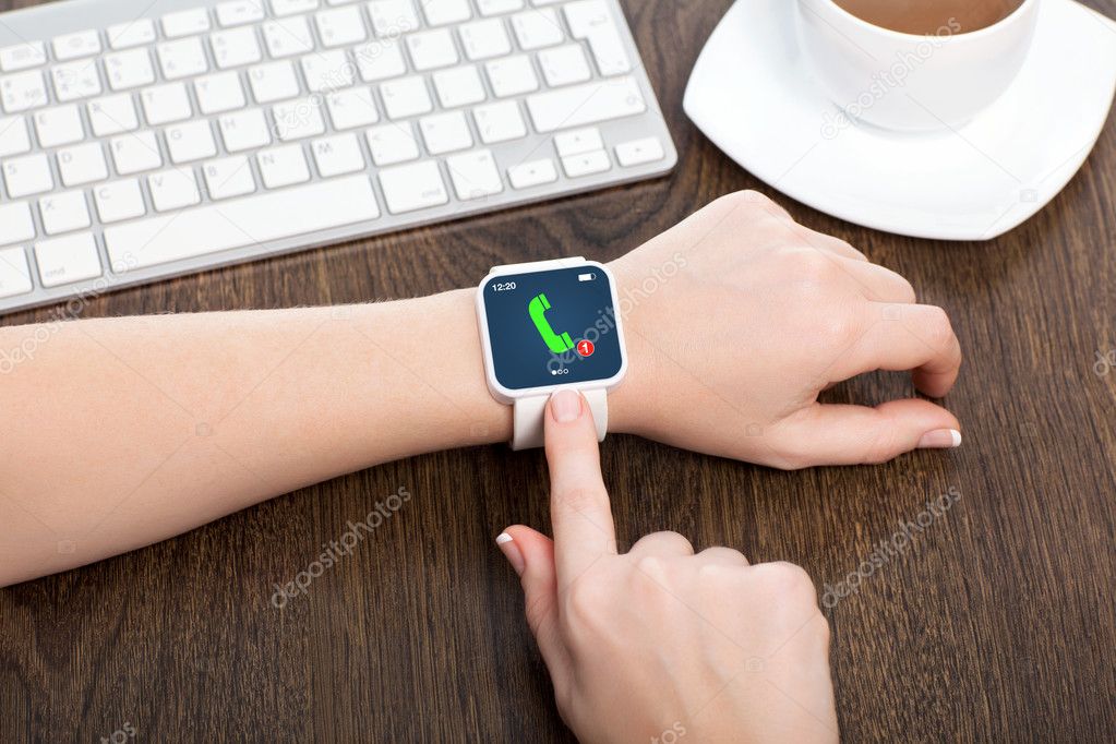 female hands with smartwatch with phone call on the screen in an