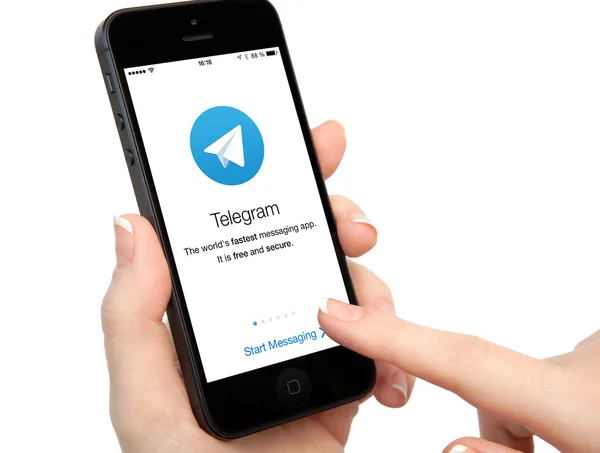 Isolated woman hands holding iPhone with Telegram on the screen — Stock Photo, Image