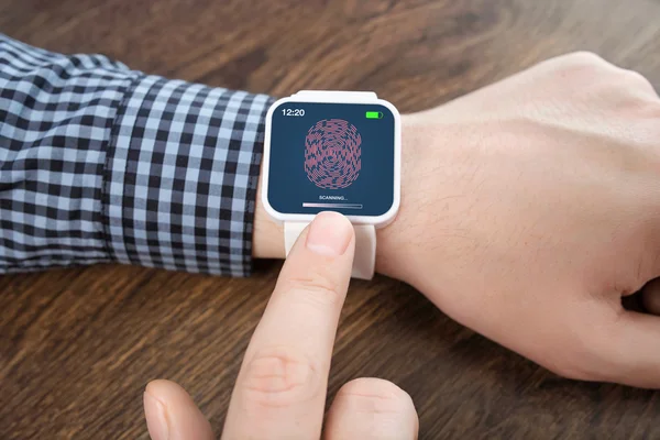 Male hands with white smartwatch with a fingerprint on the scree — Stock Photo, Image