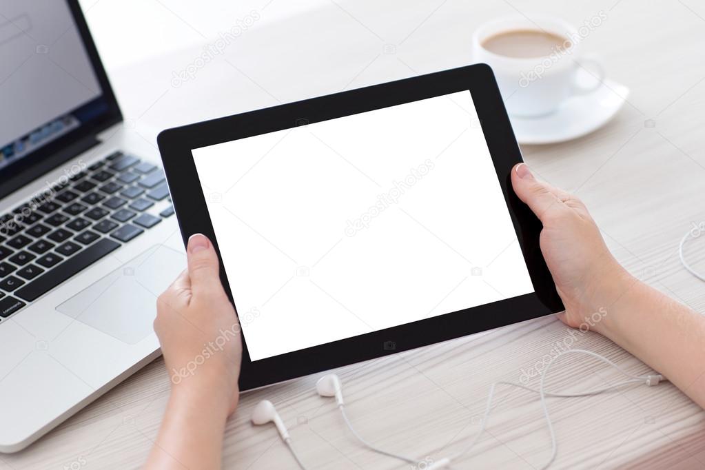 female hands holding a tablet with isolated screen against the b