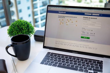 Alanya, Türkiye - 14 Mayıs 2020: Ekranda sosyal ağ hizmetleri Facebook 'u olan Macbook Pro 16' yı erkek eli ile masaya yatırın. Macbook Apple tarafından yaratıldı ve geliştirildi.