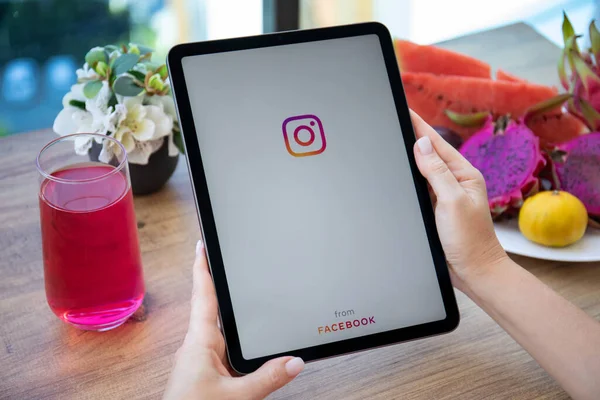 Alanya, Turkey - October 11, 2021: Women hand holding iPad Air with social networking service Instagram on the screen.