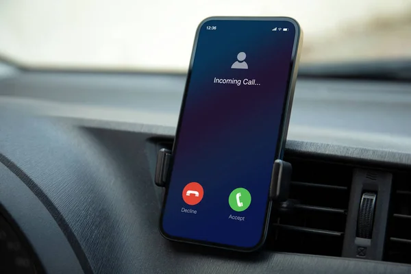 phone with incoming call on screen inside the car