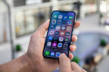 Alanya, Türkiye - 27 Eylül 2022: Ekranda IOS 16 ekranlı iPhone 14 ile el ele tutuşan adam.