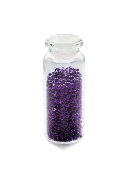 Violette Perlen im Fläschchen — Stockfoto