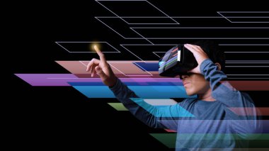 Young man using virtual reality headset. VR, future, technology online concept. Neon light. Digital Screen.