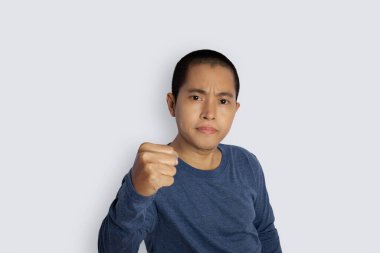 Portrait of young man with winner gesture and celebrating victory happy on gray background