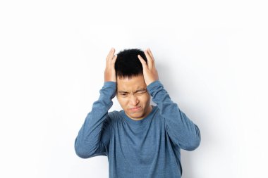 Genç adam baş ağrısı belirtisi gösteriyor ve beyaz arka planda kötü izole edilmiş..