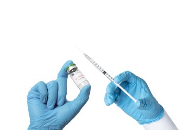 Hand wearing blue glove holding syringe and Coronavirus Vaccine in glass bottle. Syringe and Vaccine in hand. Vaccination, medical treatment and medicare concept. isolated on white background.