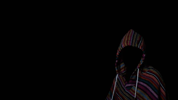Scary and creepy man hiding in the shadows, with the face and identity hidden with the hood, Dark mysterious man in hoodie on black background. Concept for fear, mystery, danger, hacker. copy space.