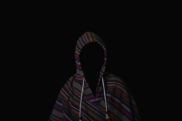 Scary and creepy man hiding in the shadows, with the face and identity hidden with the hood, Dark mysterious man in hoodie on black background. Concept for fear, mystery, danger, hacker. copy space.