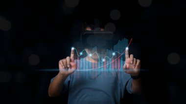 Man wearing VR Headset showing growing virtual hologram stock market, trading statistic business and increase in the indicators of positive growth, stock investment financial metaverse concept.