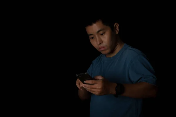 Portrait Young Man Wearing Blue Shirt Using Smartphone Black Background — Stock Fotó