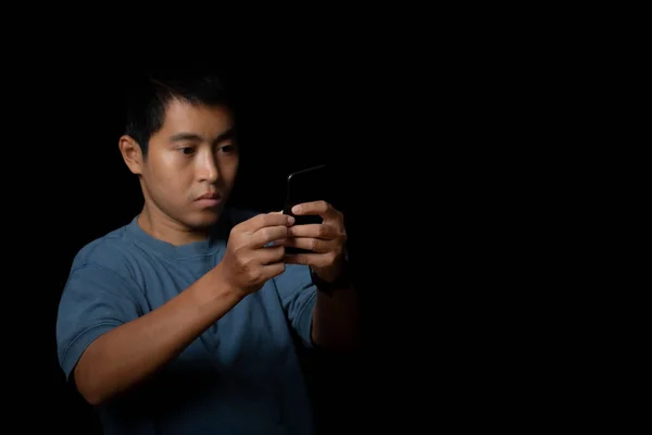Portrait Young Man Wearing Blue Shirt Using Smartphone Black Background — Stock Fotó