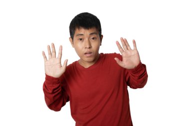 Portrait of young man show stop gesture sign by hand, hands show refusal gesture. Human emotion face expression concept. Studio shot isolated on white background. copy space