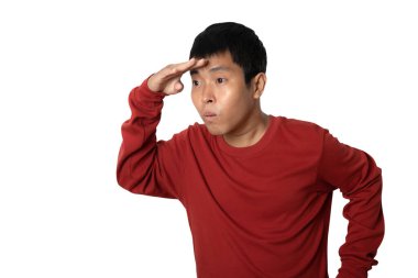 Portrait of young man holding hand at forehead look far away distance. Looking far away gesture. Human emotion face expression concept. Studio shot isolated on white background. copy space.