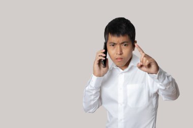 Portrait of businessman talking smartphone. Human emotion face expression concept. Studio shot isolated on gray background. copy space.