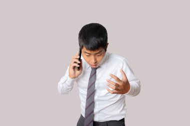 Portrait of businessman using smartphone feeling disappointed, unhappy and negative gesture. Human emotion face expression concept. Studio shot isolated on gray background. copy space.