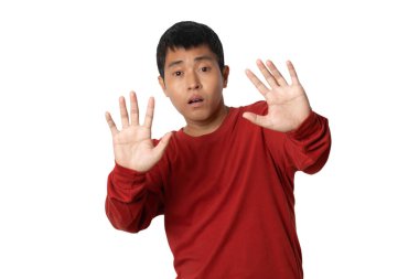 Portrait of young man show stop gesture sign by hand, hands show refusal gesture. Human emotion face expression concept. Studio shot isolated on white background. copy space