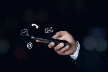 Businessman hand using smartphone with icon phone, chat message icon, mail, and address. Customer support service contact us concept. copy space.