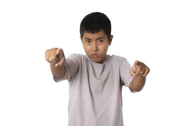 Portrait of young man pointing with his finger. presenting gesture.Human emotion face expression concept. Studio shot isolated on white background. copy space.