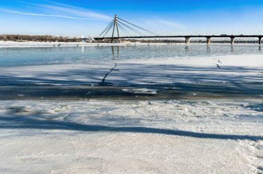 Soğuk bir kış boyunca Ukrayna 'nın Kiev kentindeki Obolon bölgesinde donmuş Dinyeper' deki balıkçılar. Arka planda Pivnichnyi (eski Moskovsky) köprüsü.