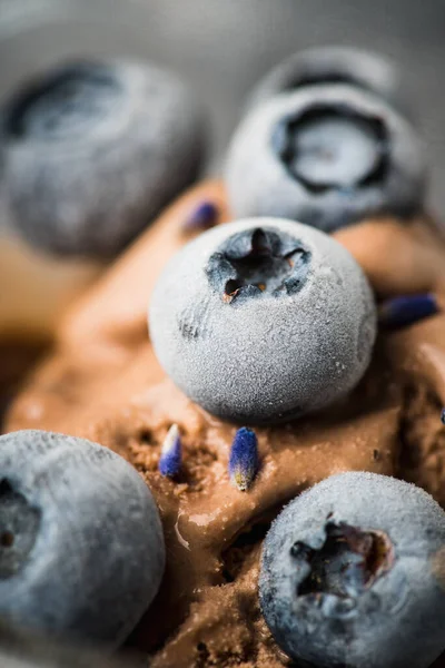 stock image Macro shot of chocolate ice cream with blueberries and lavender flowers. Selective focus. Shallow depth of field.