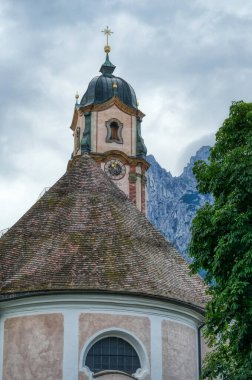 Historical church tower and Karwendel peaks in Mittenwald