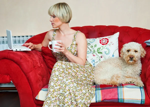 Woman and dog on sofa Royalty Free Stock Images