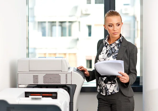 Mujer trabajando en fotocopiadora — Foto de Stock