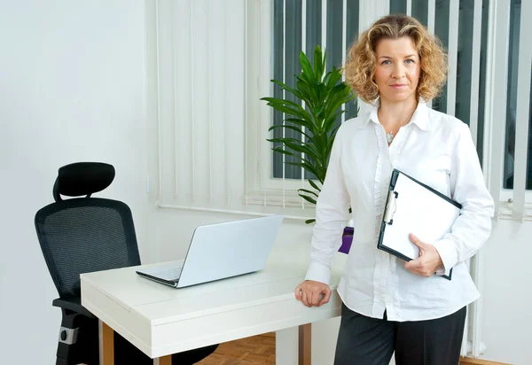 Mature woman in her office — Stock Photo, Image