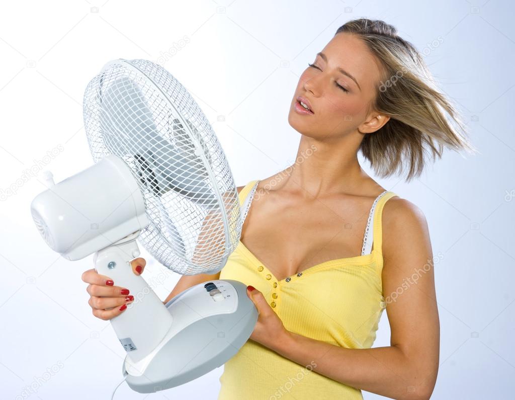 teen girl cooling herself with fan