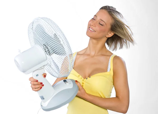 Teen girl cooling herself with fan — Stok fotoğraf