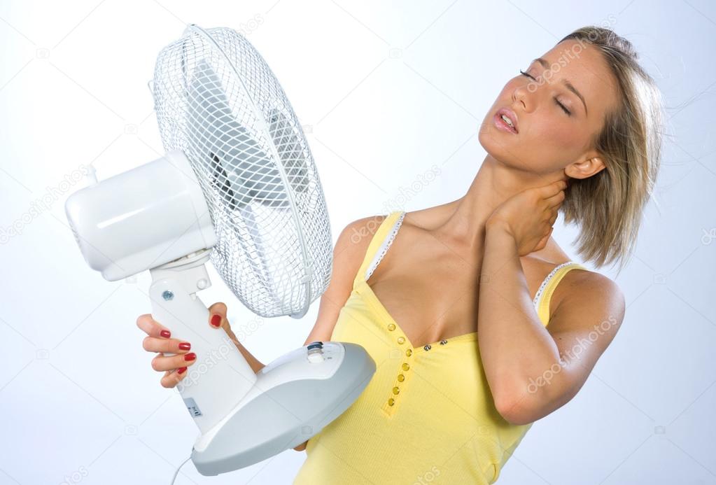 teen girl cooling herself with fan