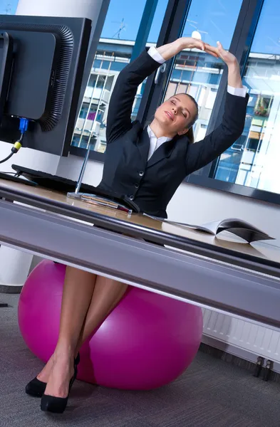 Frau dehnt sich im Büro — Stockfoto