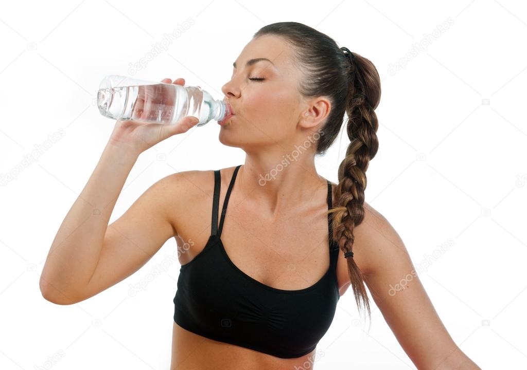 woman drinking water after exercise