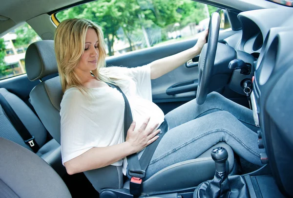 Mujer embarazada en el coche Fotos De Stock