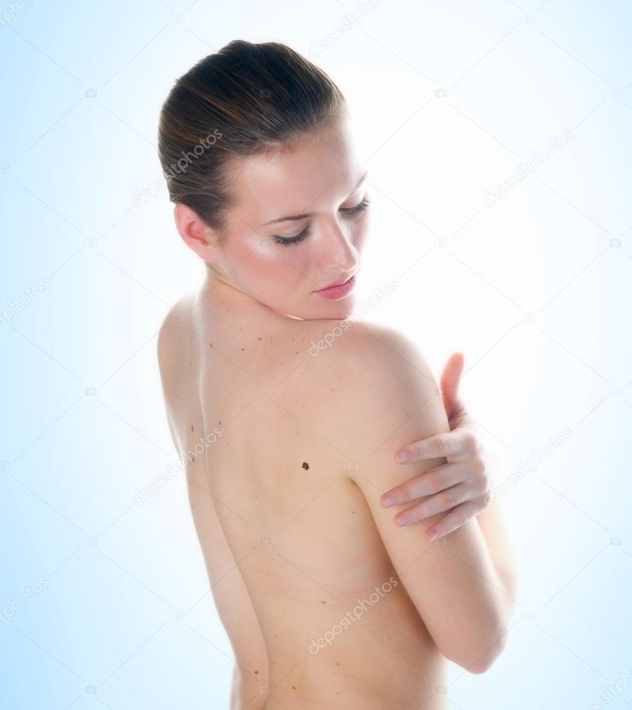 woman looking mall on her skin